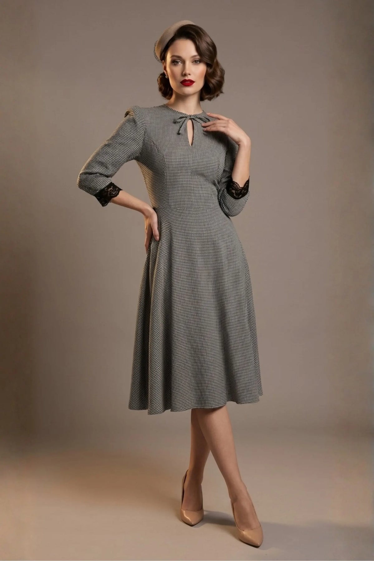 Woman wearing a diva catwalk Alanna Dogtooth Tie-Detail A-Line Dress | Diva Catwalk with long sleeves against a plain background (Petite Dogtooth Check)