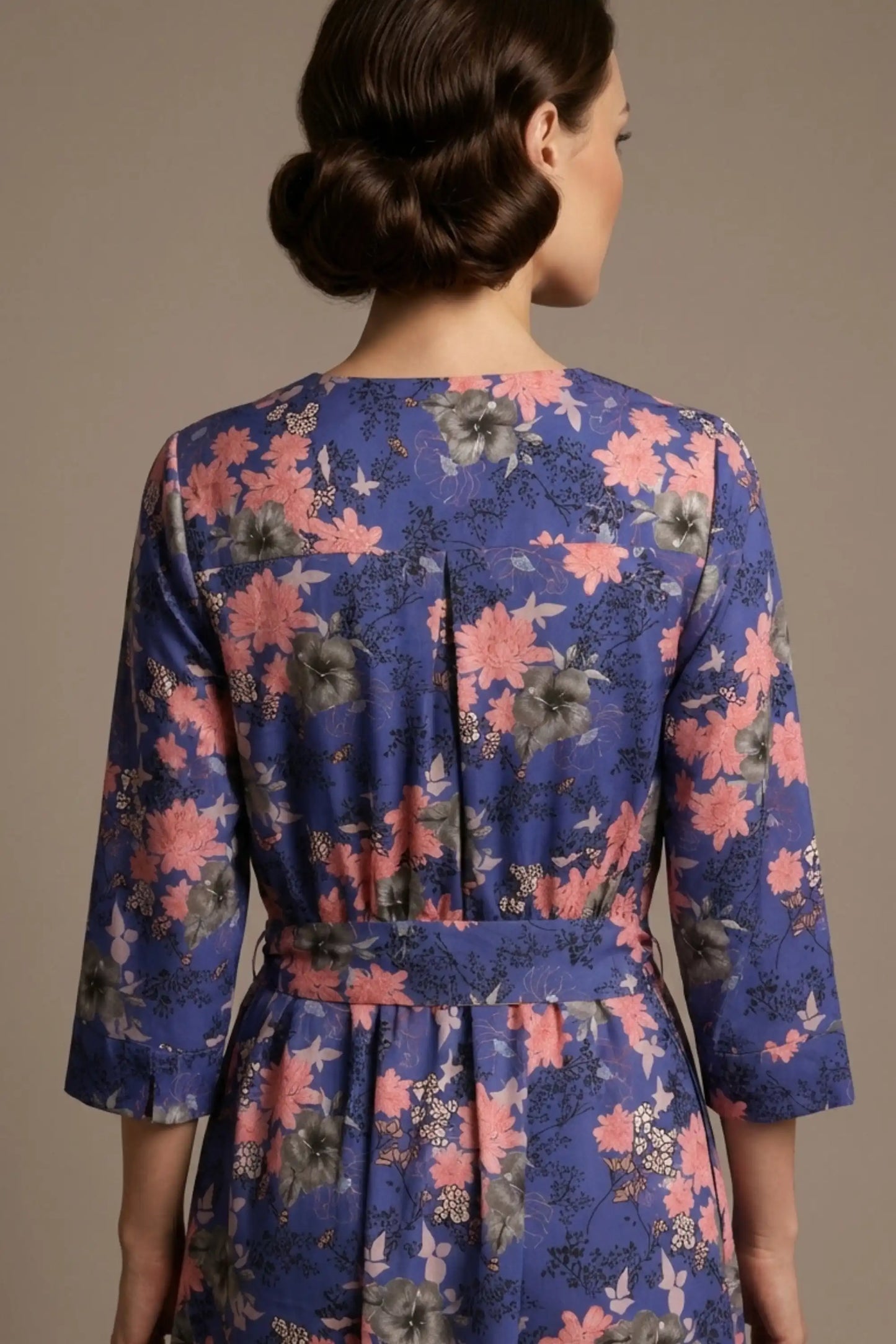 A model showcasing the vintage-inspired Zuleika floral midi dress, styled with retro accessories, highlighting the cinched tie-waist and V-notch neckline (Chelsea Garden Bloom Print)