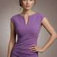Woman wearing a purple dress against a neutral background (Purple Heart)