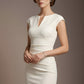 Woman wearing a white dress against a brown background (Vanilla Cream)