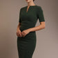 Woman wearing a green dress against a brown background (Deep Green)