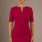 Woman wearing a red dress against a brown background (Rose Red)