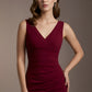 Woman wearing a burgundy dress against a brown background (Cabaret Burgundy)