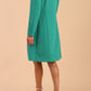 model wearing diva catwalk teal coat with long sleeves and a belt in Emerald Green back