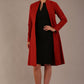 blonde model wearing diva catwalk couture fine raquella coat with buttons across the front and long sleeves with high neck and pockets in garnet red colour front (Garnet Red)