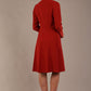 blonde model wearing diva catwalk couture fine raquella coat with buttons across the front and long sleeves with high neck and pockets in garnet red colour back (Garnet Red)