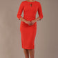 model wearing diva catwalk ubrique pencil dress with a keyhole detail and sleeves in Grenadine Orange  (Grenadine Orange)