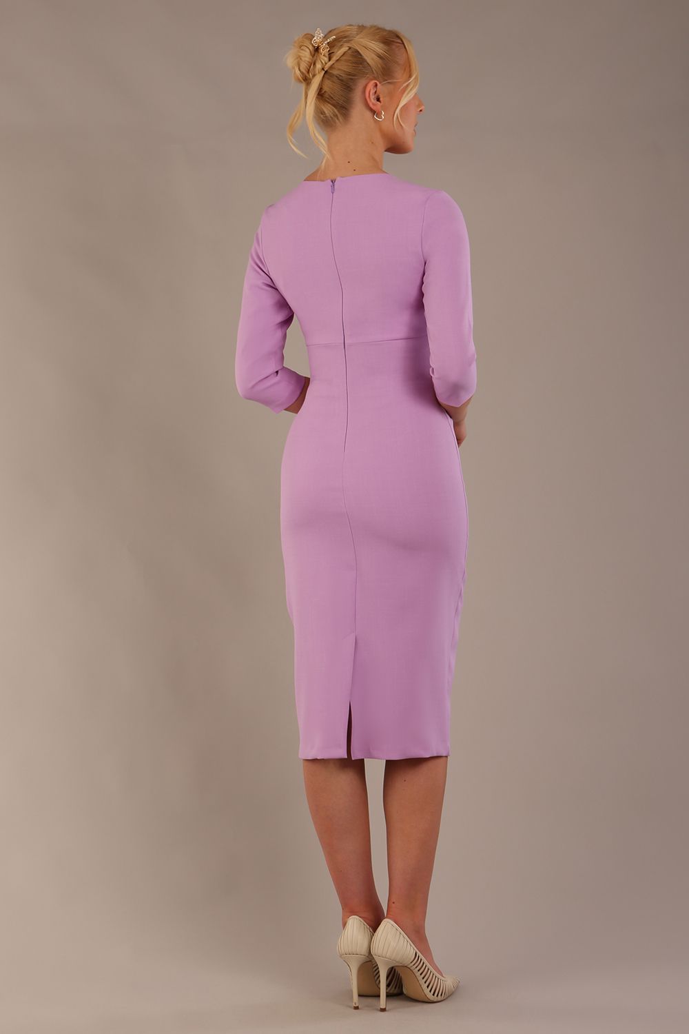 The model is wearing the Diva Catwalk Ubrique pencil dress with Long sleeves and keyhole detail in Sheer Lilac fabric colour back (Sheer Lilac)