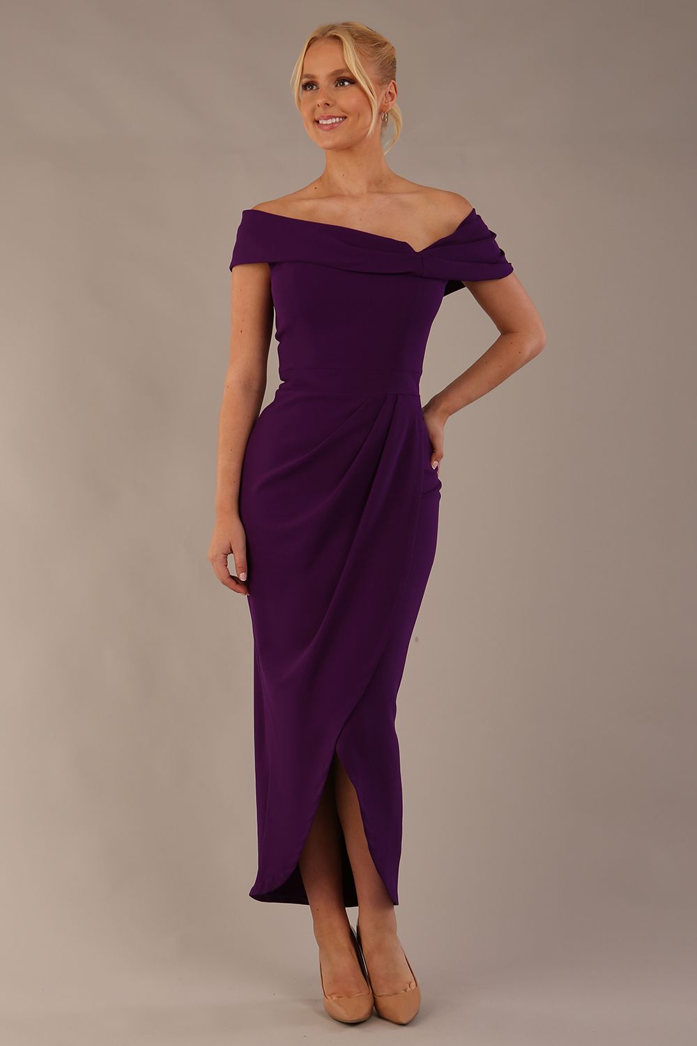 model wearing diva catwalk vegas calf length passion purple midaxi dress with wide bardot neckline and open shoulders with a large opening at the front of the skirt with pleating coming down long skirt front (Passion Purple)