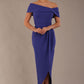 model wearing diva catwalk vegas calf length spectrum indigo midaxi dress with wide bardot neckline and open shoulders with a large opening at the front of the skirt with pleating coming down long skirt front (Spectrum Indigo)