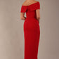 model wearing diva catwalk vegas calf length midaxi dress with wide bardot neckline and open shoulders with a large opening at the front of the skirt with pleating coming down long skirt back in scarlet red (Scarlet Red)
