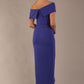 model wearing diva catwalk vegas calf length spectrum indigo midaxi dress with wide bardot neckline and open shoulders with a large opening at the front of the skirt with pleating coming down long skirt back (Spectrum Indigo)