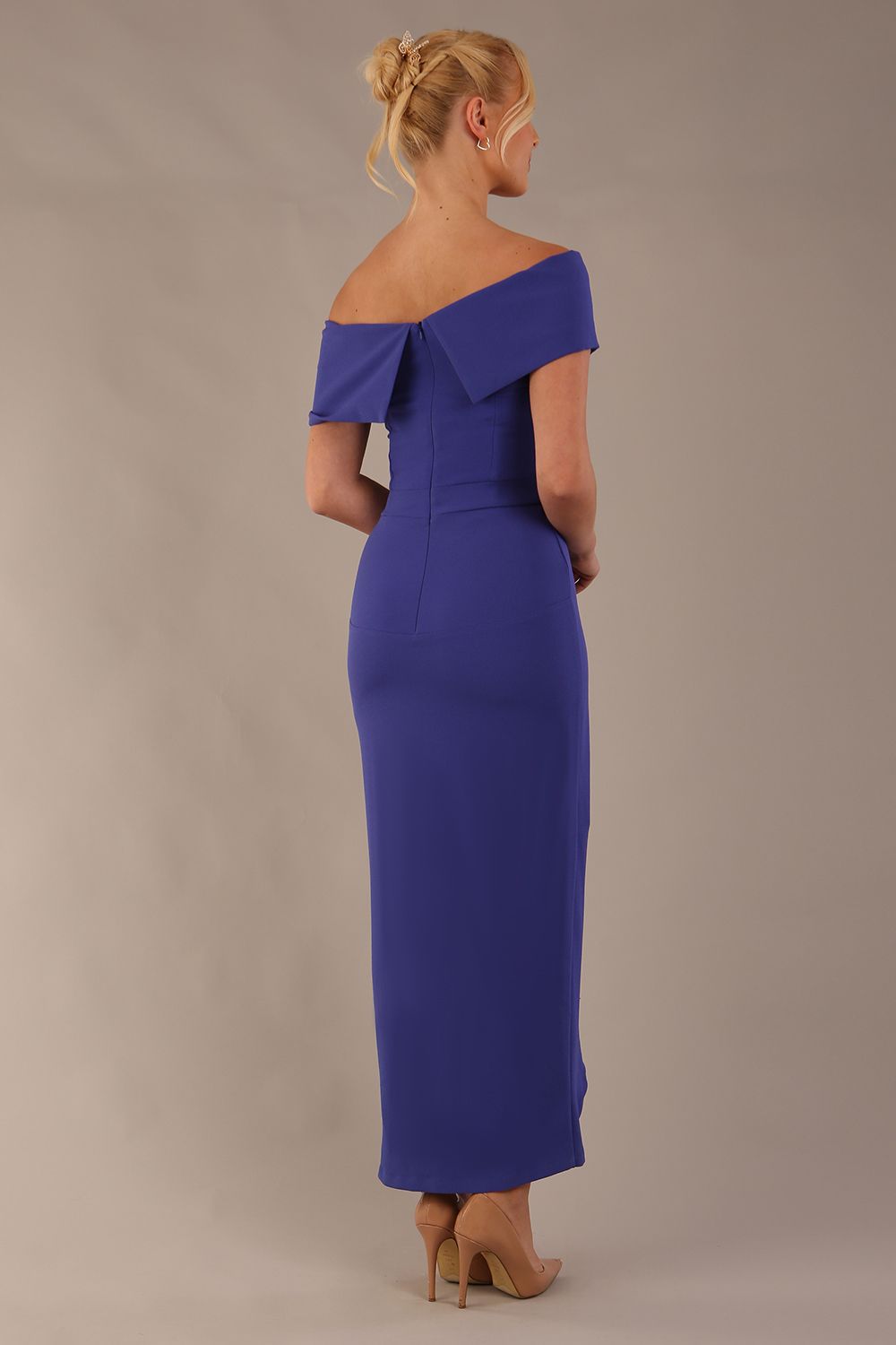 model wearing diva catwalk vegas calf length spectrum indigo midaxi dress with wide bardot neckline and open shoulders with a large opening at the front of the skirt with pleating coming down long skirt back (Spectrum Indigo)