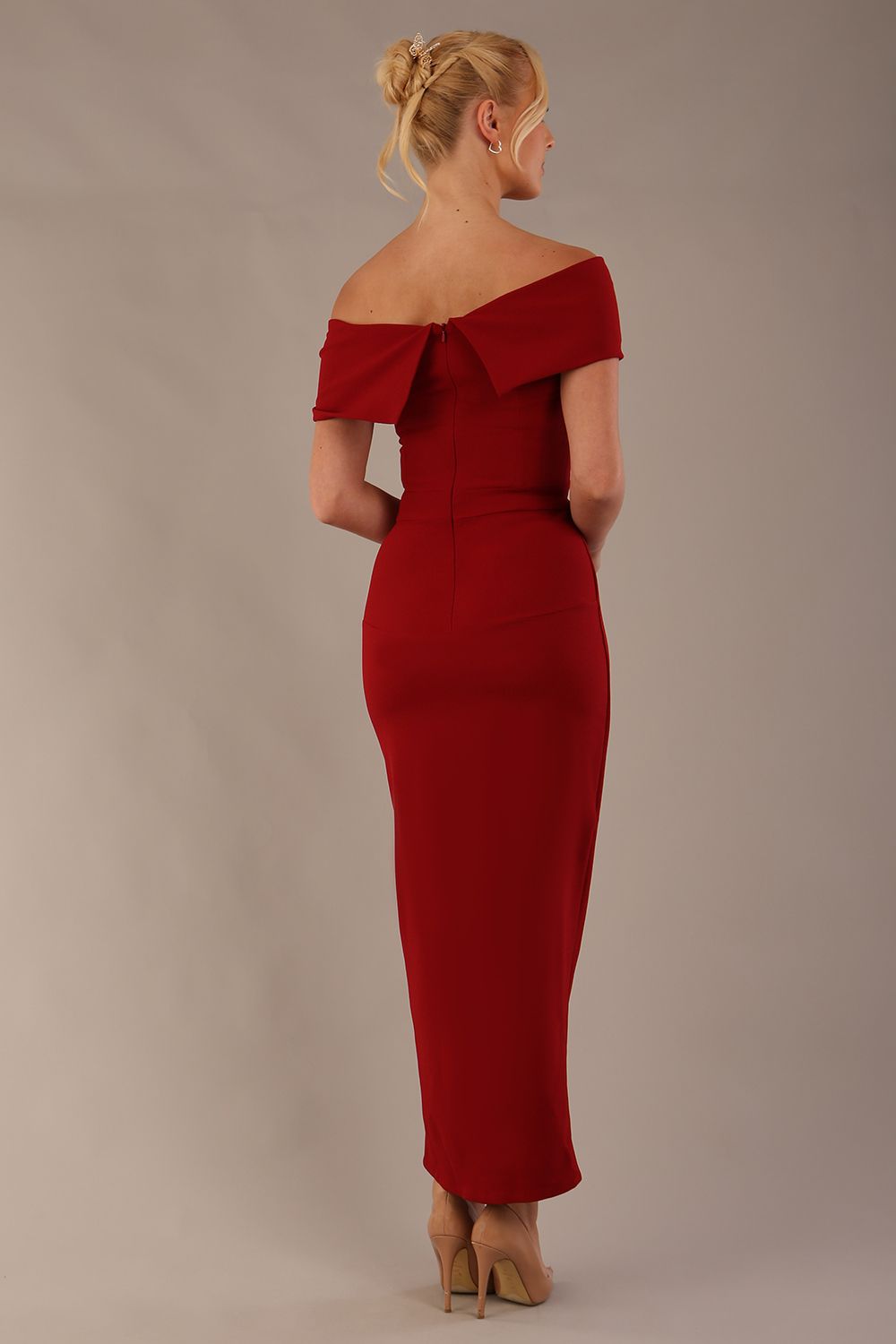 model wearing diva catwalk vegas calf length rosewood red midaxi dress with wide bardot neckline and open shoulders with a large opening at the front of the skirt with pleating coming down long skirt back (Rosewood Red)