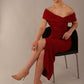 model wearing diva catwalk vegas calf length rosewood red midaxi dress with wide bardot neckline and open shoulders with a large opening at the front of the skirt with pleating coming down long skirt front (Rosewood Red)