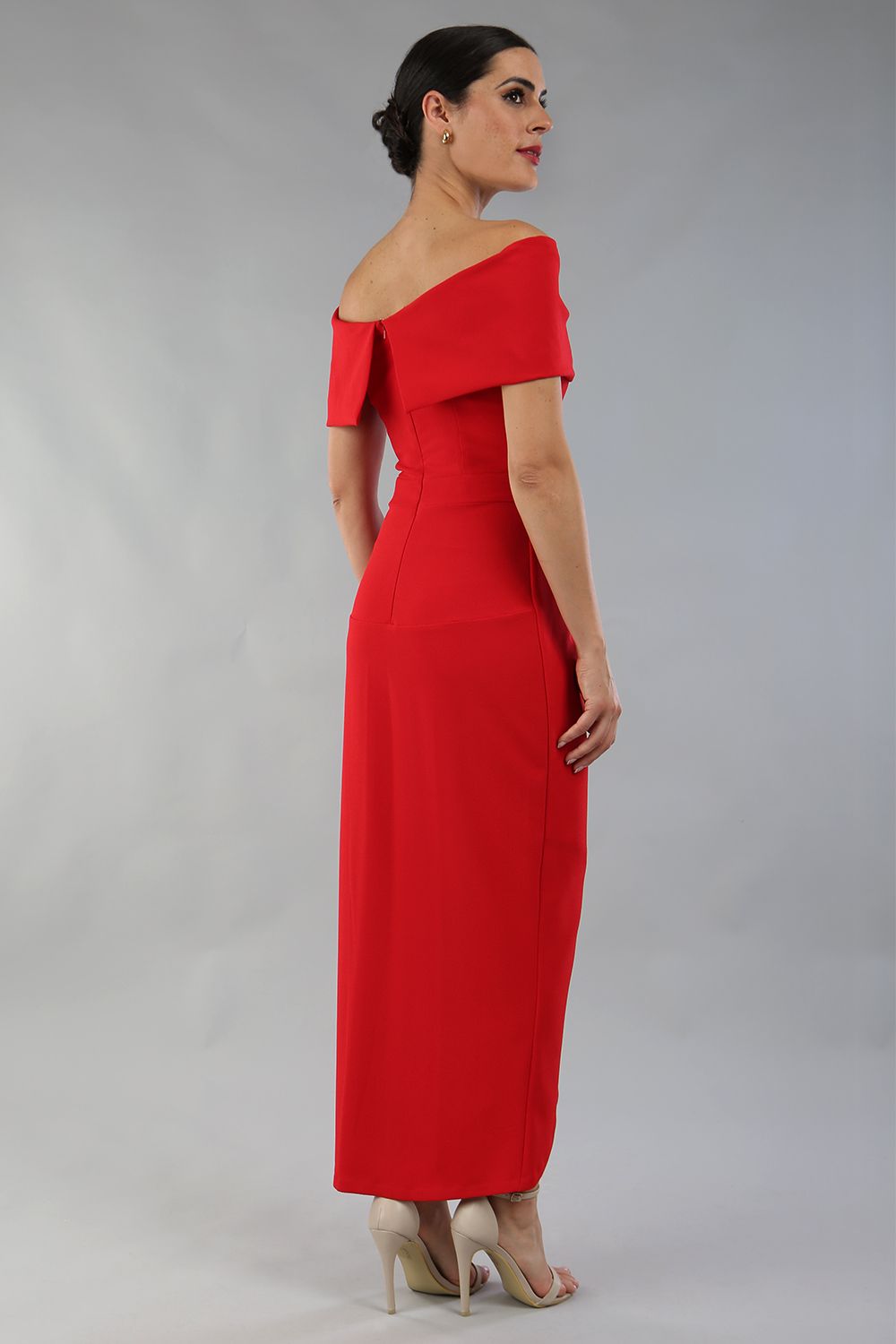model wearing diva catwalk vegas calf length midaxi dress with wide bardot neckline and open shoulders with a large opening at the front of the skirt with pleating coming down long skirt back in scarlet red (Scarlet Red)