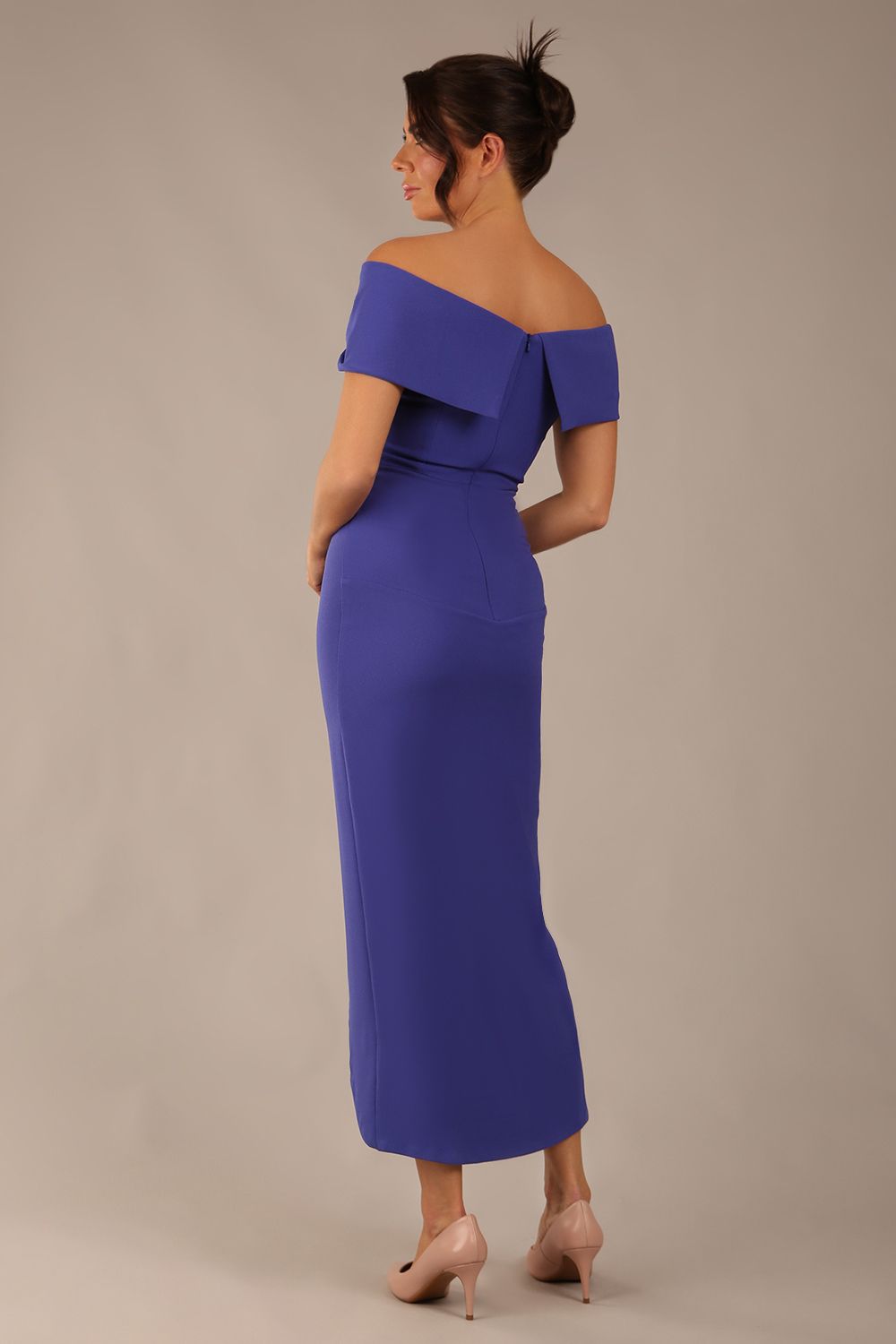 model wearing diva catwalk vegas calf length spectrum indigo midaxi dress with wide bardot neckline and open shoulders with a large opening at the front of the skirt with pleating coming down long skirt back (Spectrum Indigo)