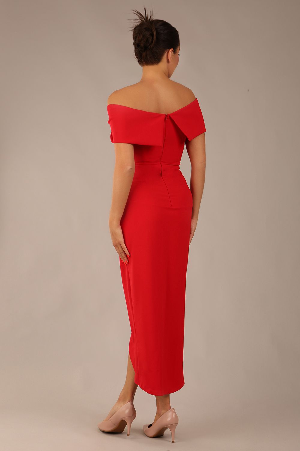 brunette model wearing diva catwalk vegas calf length midaxi dress with wide bardot neckline and open shoulders with a large opening at the front of the skirt with pleating coming down long skirt back in scarlet red (Scarlet Red)