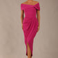 brunette model wearing diva catwalk vegas calf length magenta midaxi dress with wide bardot neckline and open shoulders with a large opening at the front of the skirt with pleating coming down long skirt front (Magenta)