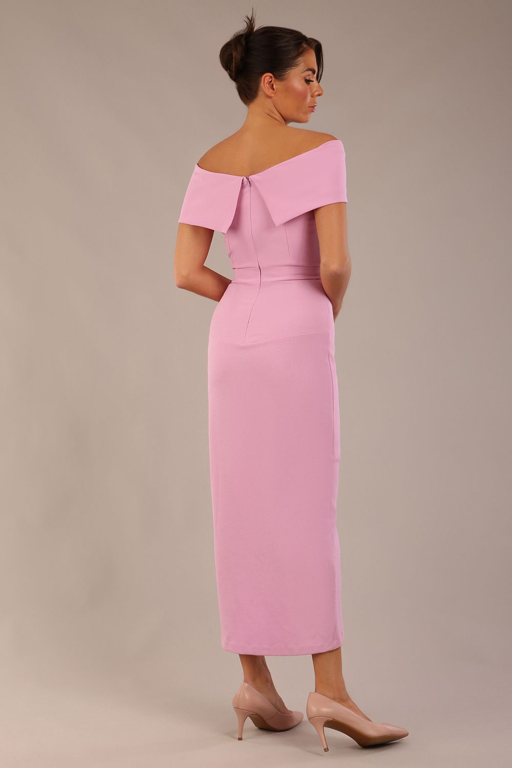 brunette model wearing diva catwalk vegas calf length dawn pink midaxi dress with wide bardot neckline and open shoulders with a large opening at the front of the skirt with pleating coming down long skirt back (Dawn Pink)