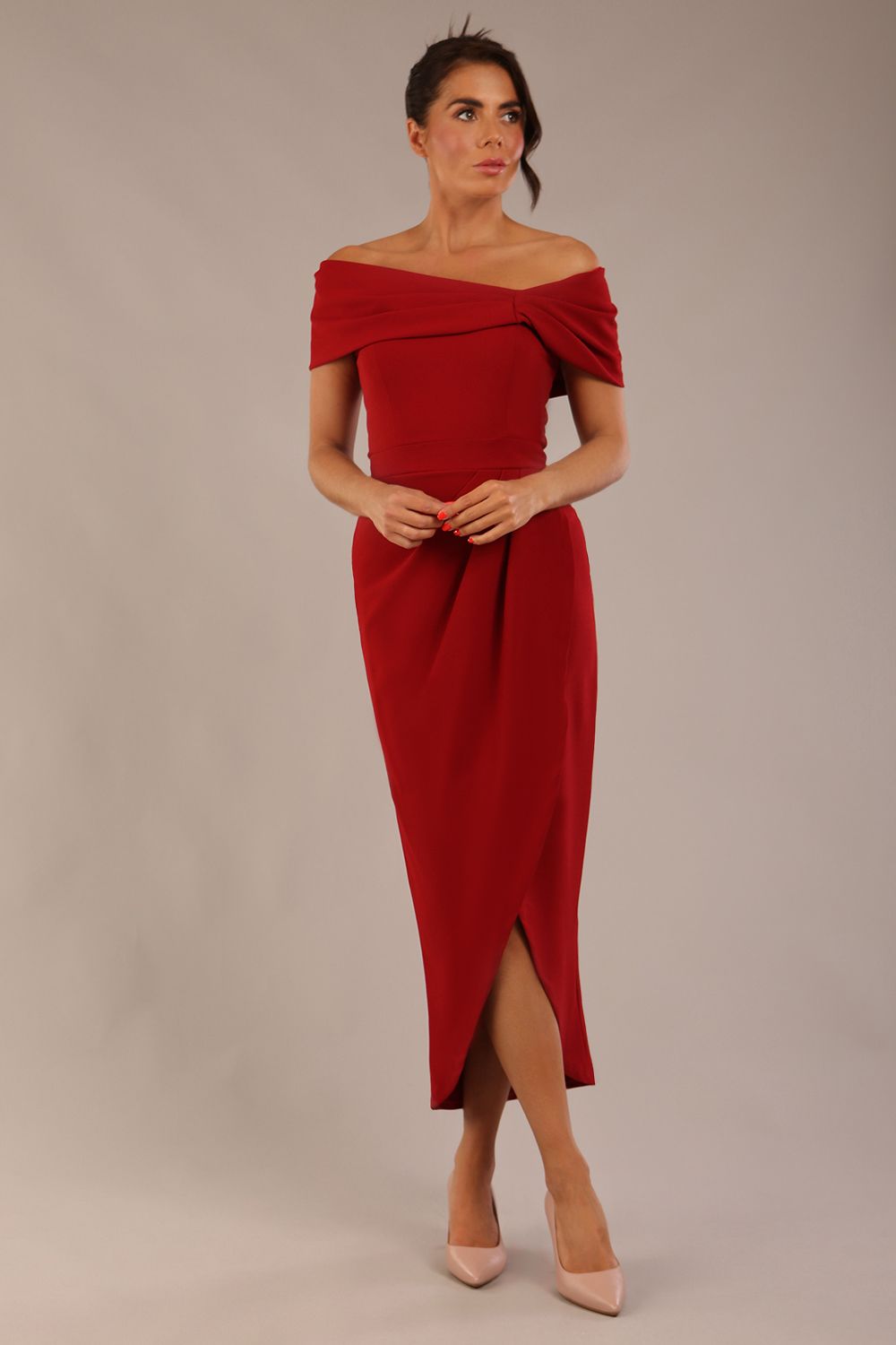 brunette model wearing diva catwalk vegas calf length rosewood red midaxi dress with wide bardot neckline and open shoulders with a large opening at the front of the skirt with pleating coming down long skirt front (Rosewood Red)