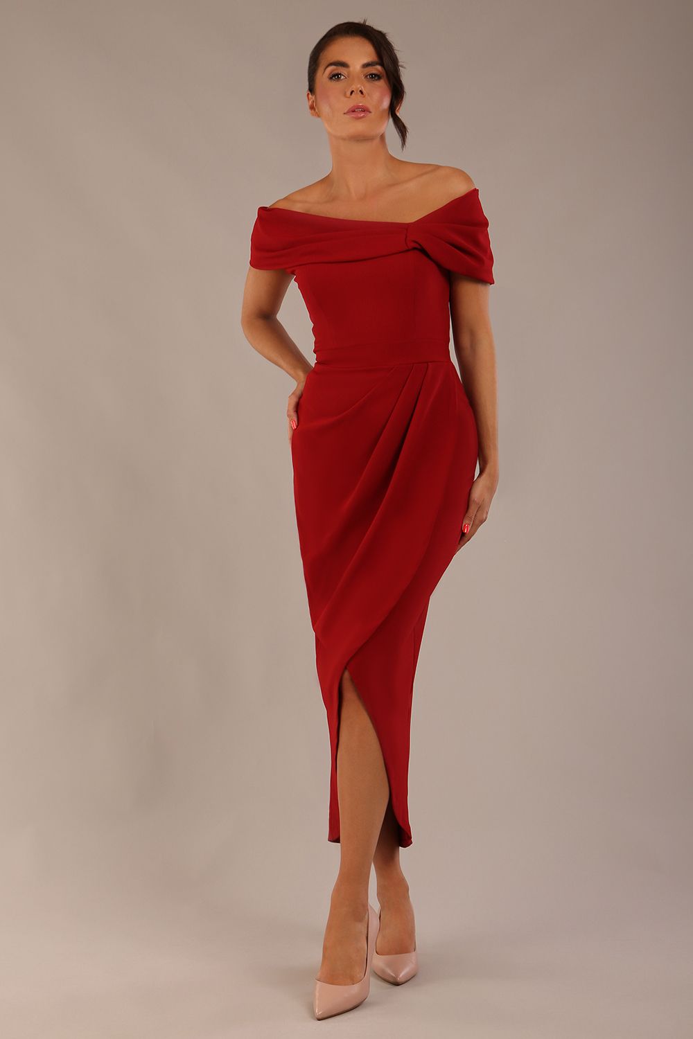 brunette model wearing diva catwalk vegas calf length rosewood red midaxi dress with wide bardot neckline and open shoulders with a large opening at the front of the skirt with pleating coming down long skirt front (Rosewood Red)