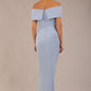 brunette model wearing diva catwalk vegas calf length powder blue midaxi dress with wide bardot neckline and open shoulders with a large opening at the front of the skirt with pleating coming down long skirt front (Powder Blue)