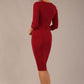 brunette model wearing a Diva Catwalk pencil three quarter sleeve dress with a split neckline and pleating across the tummy and round neck in merlot red colour back