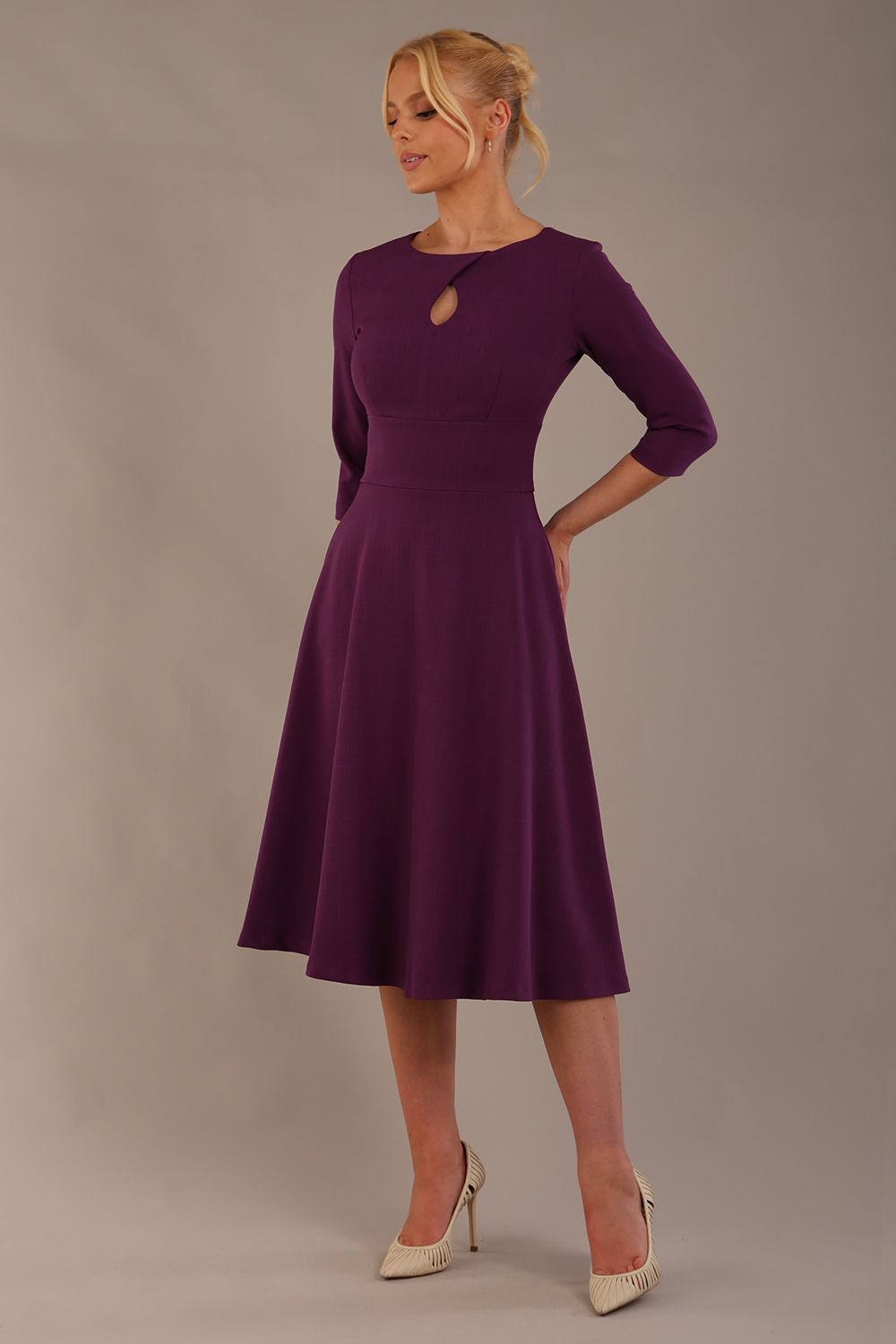 model is wearing diva catwalk casares swing dress with a keyhole neckline three quarter sleeve dress with pocket detail in imperial purple side front (Imperial Purple)
