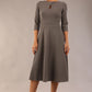 Brunette model is wearing diva catwalk casares swing dress with a keyhole neckline three quarter sleeve dress with pocket detail in Castlerock Grey  front (Castlerock Grey)