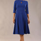 Brunette model is wearing diva catwalk casares swing dress with a keyhole neckline three quarter sleeve dress with pocket detail in cobalt blue front (Cobalt Blue)