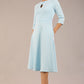 Brunette model is wearing diva catwalk casares swing dress with a keyhole neckline three quarter sleeve dress with pocket detail in sky blue front (Sky Blue)