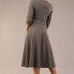 Brunette model is wearing diva catwalk casares swing dress with a keyhole neckline three quarter sleeve dress with pocket detail in Castlerock Grey back (Castlerock Grey)