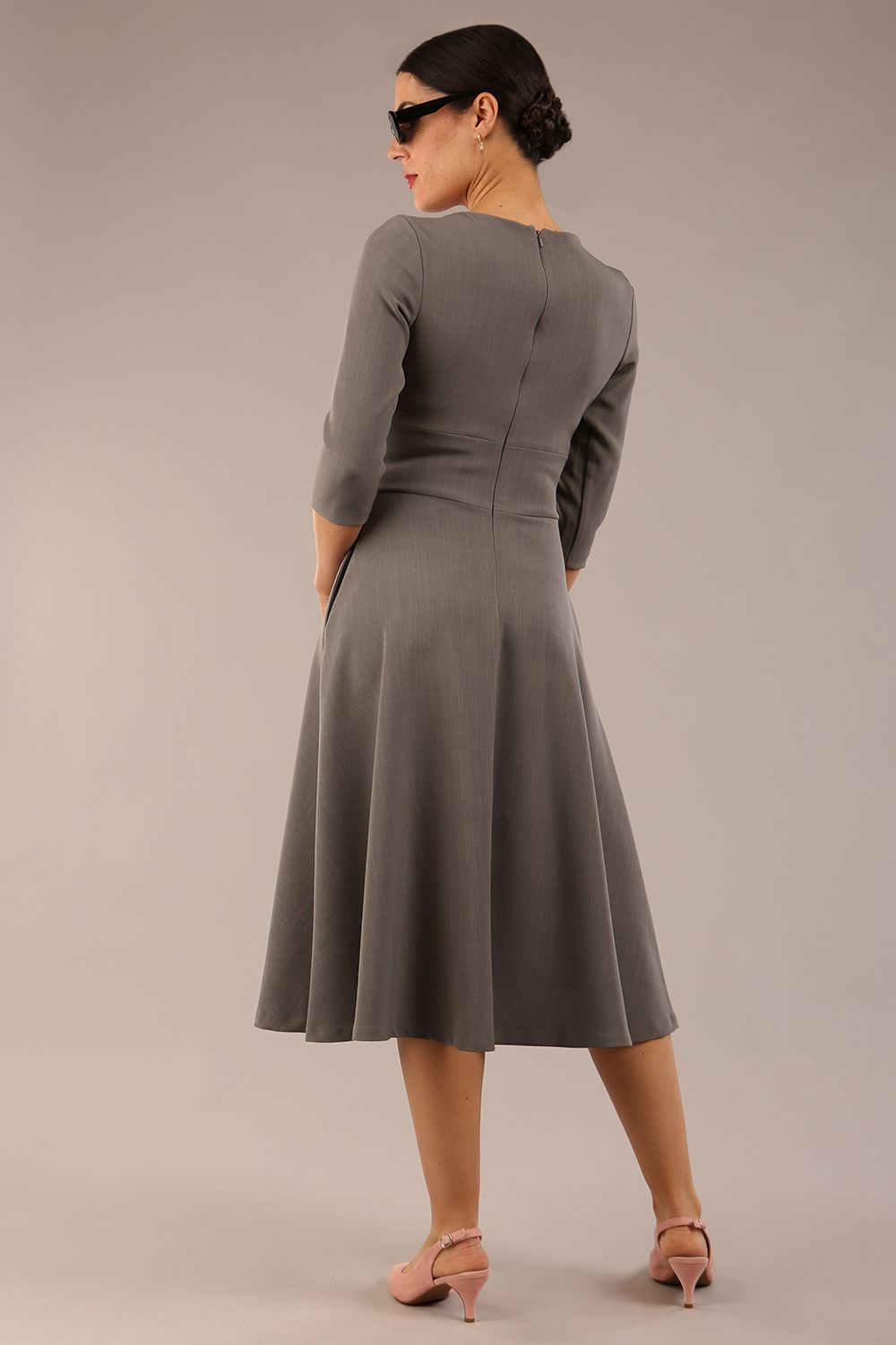 Brunette model is wearing diva catwalk casares swing dress with a keyhole neckline three quarter sleeve dress with pocket detail in Castlerock Grey back (Castlerock Grey)