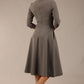 Brunette model is wearing diva catwalk casares swing dress with a keyhole neckline three quarter sleeve dress with pocket detail in Castlerock Grey  back (Castlerock Grey)