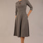 Brunette model is wearing diva catwalk casares swing dress with a keyhole neckline three quarter sleeve dress with pocket detail in Castlerock Grey  front (Castlerock Grey)