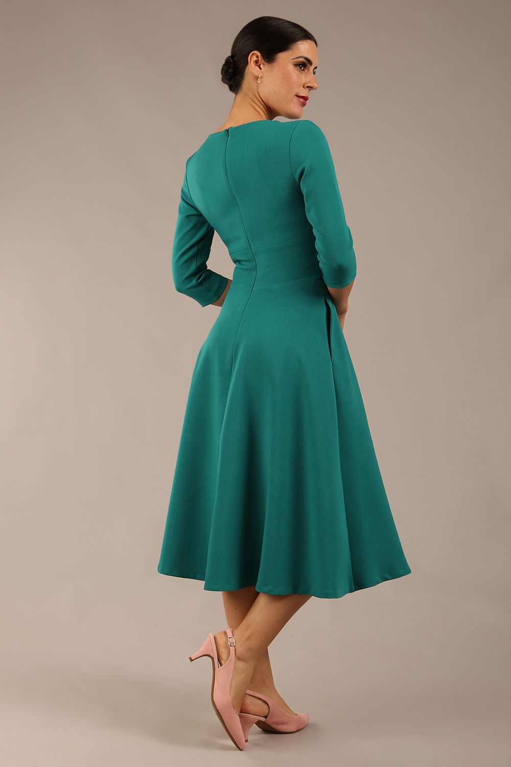 Brunette model is wearing diva catwalk casares swing dress with a keyhole neckline three quarter sleeve dress with pocket detail in Parasailing green back (Parasailing Green)