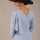 brunette model is wearing a diva catwalk Frieth Gathered Shoulder Dress 3/4 sleeves knee length with shoulder detail in powder blue colour back image (Powder Blue)