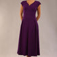 brunette model is wearing a diva catwalk Audrey Dress With Pockets sleeveless and ankle length in passion purple colour