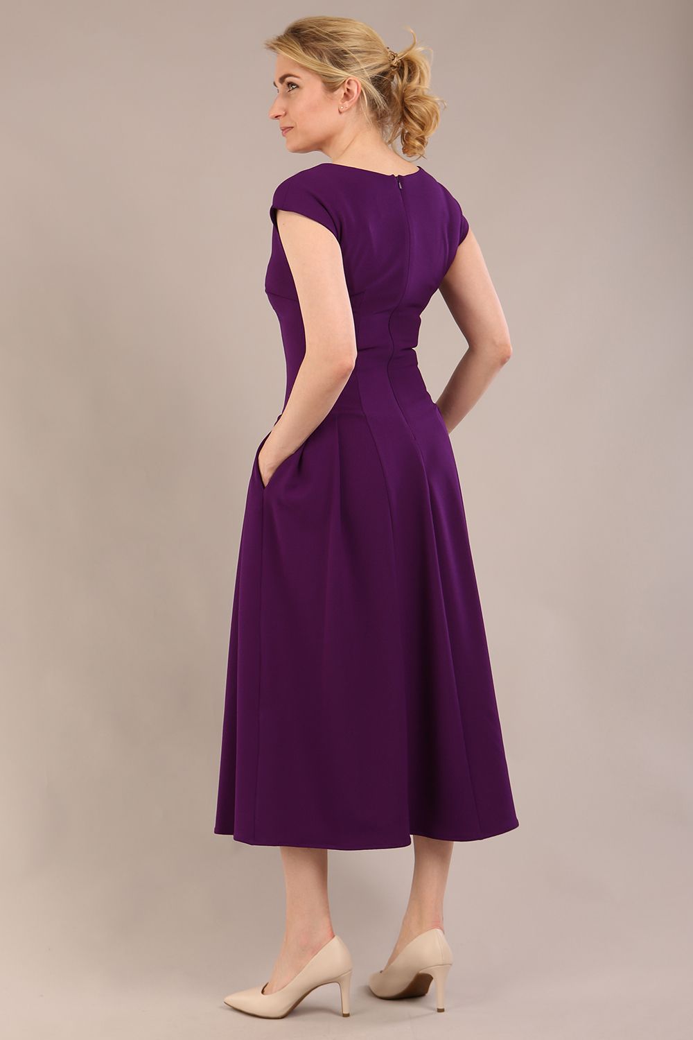 blonde model is wearing a diva catwalk Audrey Dress With Pockets sleeveless and ankle length in passion purple colour