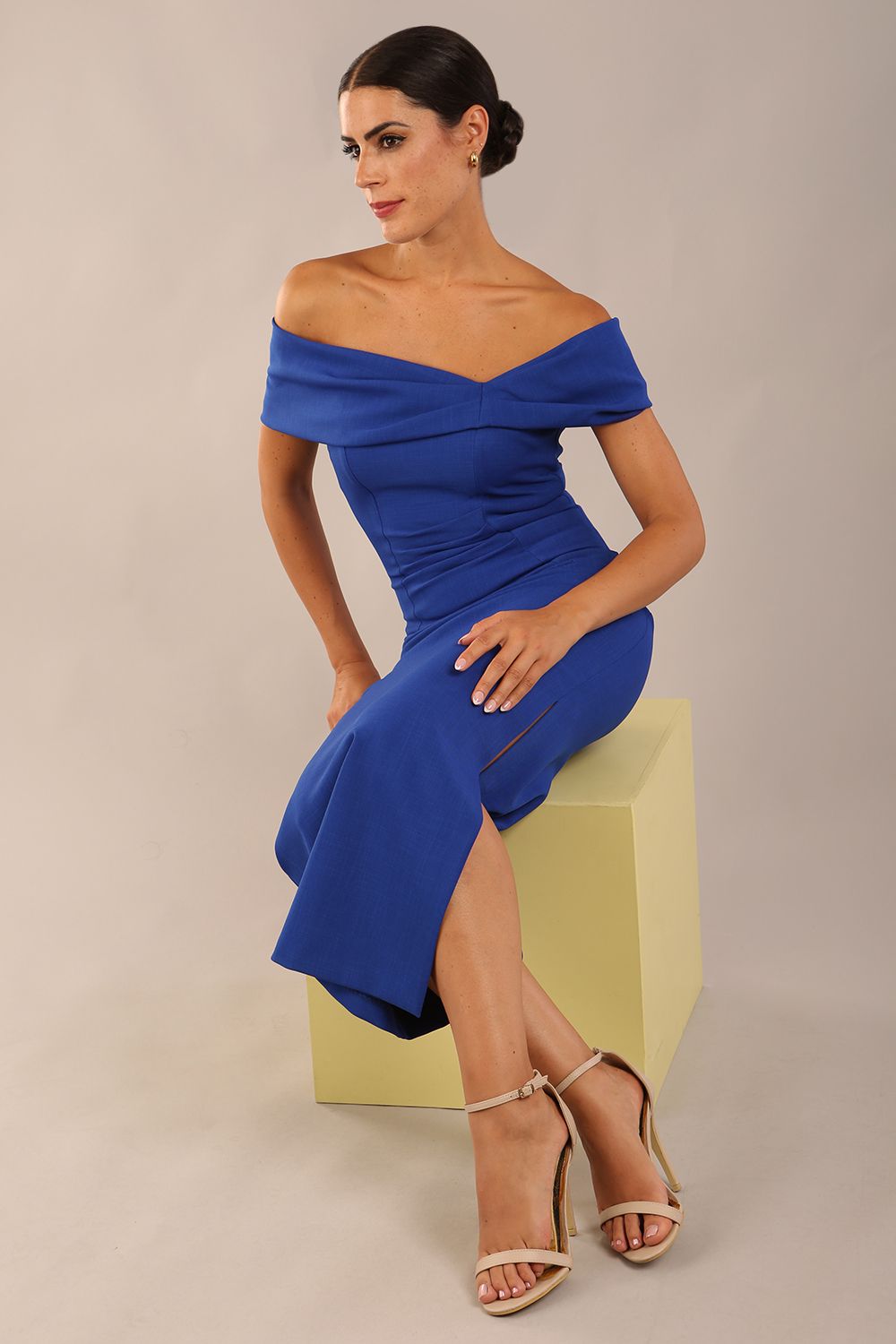model is wearing a diva catwalk Mariposa Longer Length Dress off the shoulder bardot neckline and midaxi length in cobalt blue colour