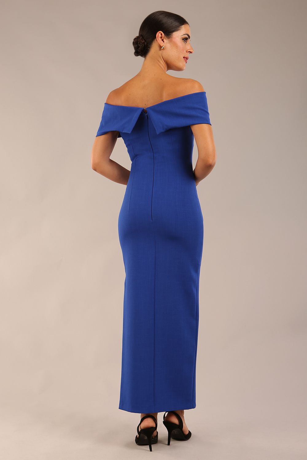 model is wearing a diva catwalk Mariposa Longer Length Dress off the shoulder bardot neckline and midaxi length in cobalt blue colour