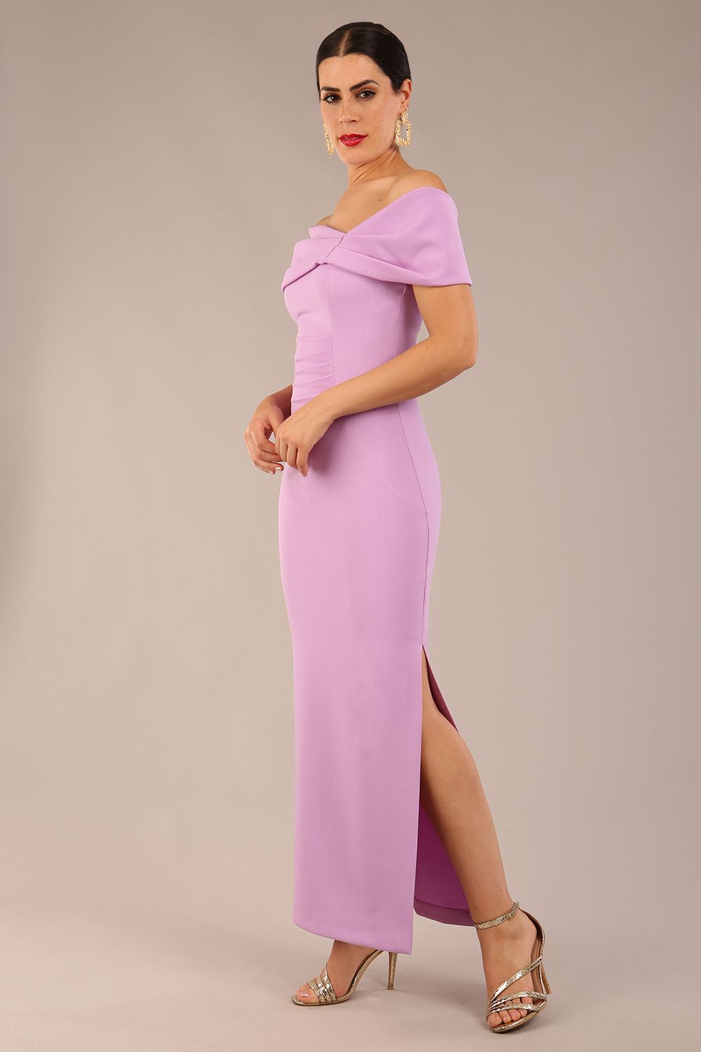 brunette model is wearing a diva catwalk Mariposa Longer Length Dress off the shoulder bardot neckline and midaxi length in sheer lilac colour front image