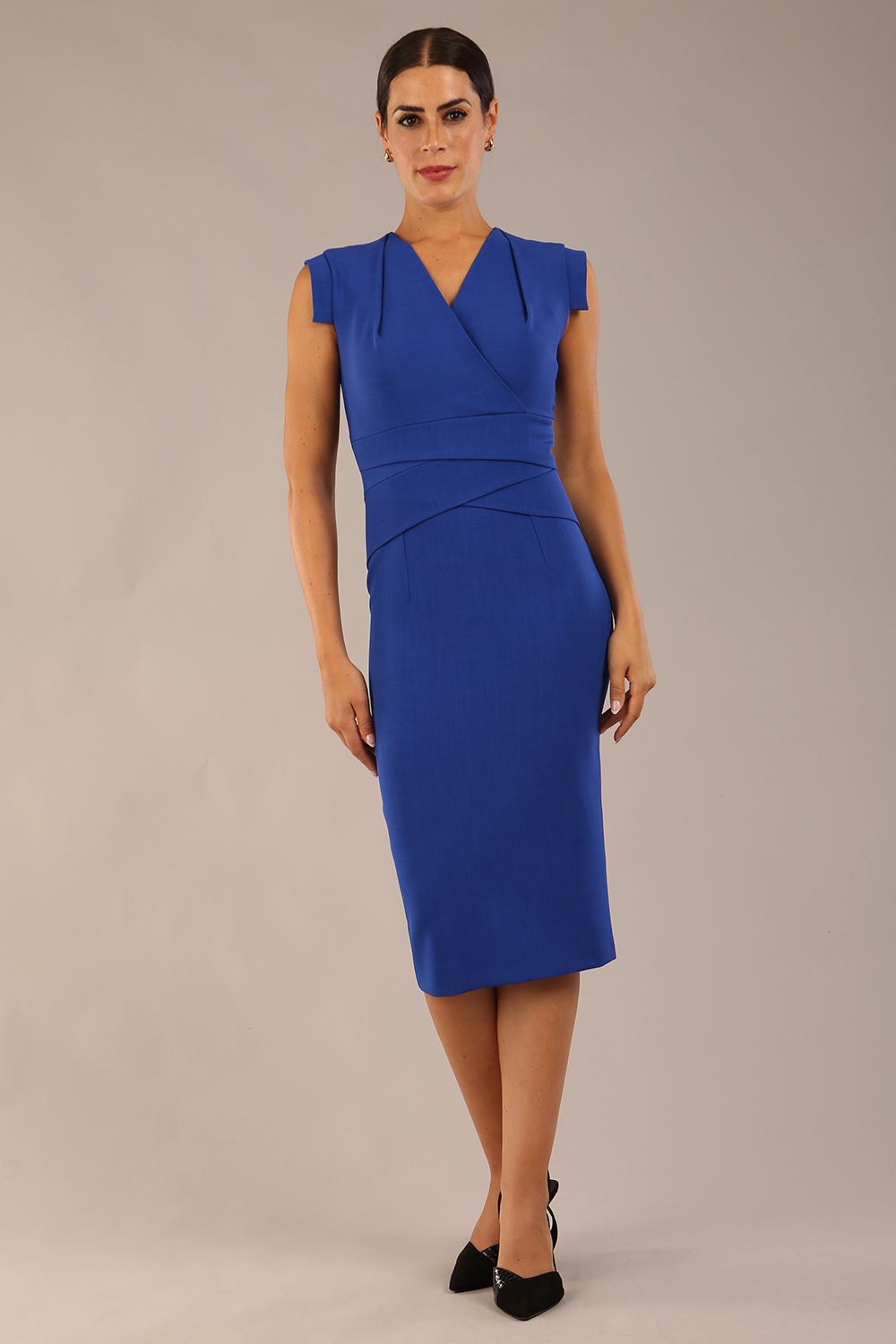 model wearing a diva catwalk Caprice Cap Sleeved Pencil Dress cap sleeve v neckline knee length with pleating details in cobalt blue colour (Cobalt Blue)