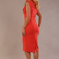 model wearing a diva catwalk Caprice Cap Sleeved Pencil Dress cap sleeve v neckline knee length with pleating details in grenadine orange colour back (Grenadine Orange)
