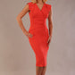 model wearing a diva catwalk Caprice Cap Sleeved Pencil Dress cap sleeve v neckline knee length with pleating details in grenadine orange colour front (Grenadine Orange)