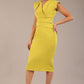 model wearing a diva catwalk Caprice Cap Sleeved Pencil Dress cap sleeve v neckline knee length with pleating details in citrus green colour (Citrus Green)