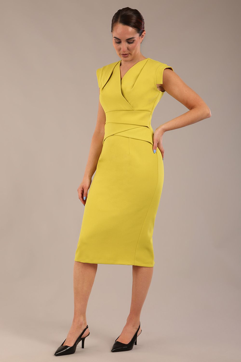 model wearing a diva catwalk Caprice Cap Sleeved Pencil Dress cap sleeve v neckline knee length with pleating details in citrus green colour (Citrus Green)