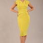 model wearing a diva catwalk Caprice Cap Sleeved Pencil Dress cap sleeve v neckline knee length with pleating details in citrus green colour (Citrus Green)