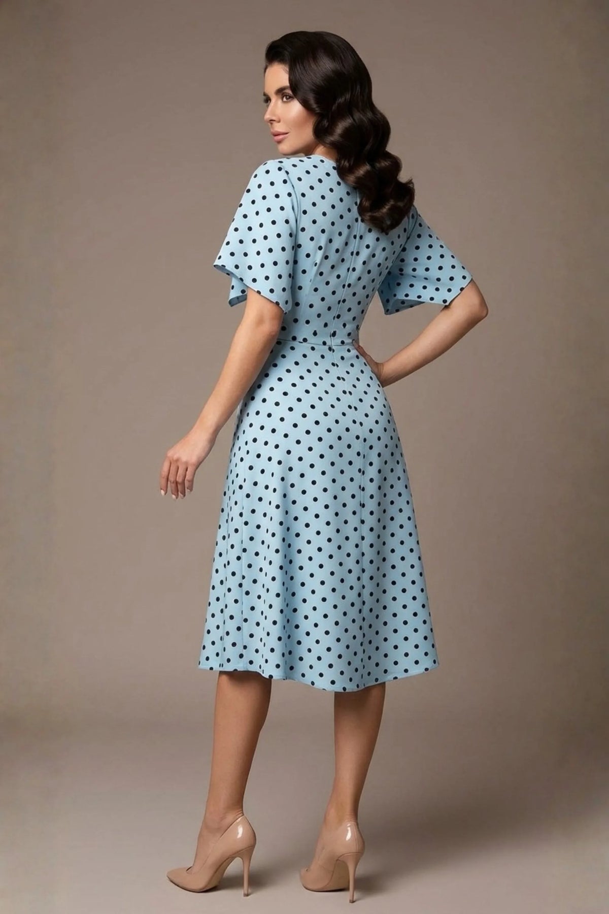 brunette model is wearing a diva catwalk Anastasia Polka Dot Bell Sleeves & A-Line Skirt Midi Dress a-line dress in sky blue polka dot back image (Sky Blue Polka Dot)